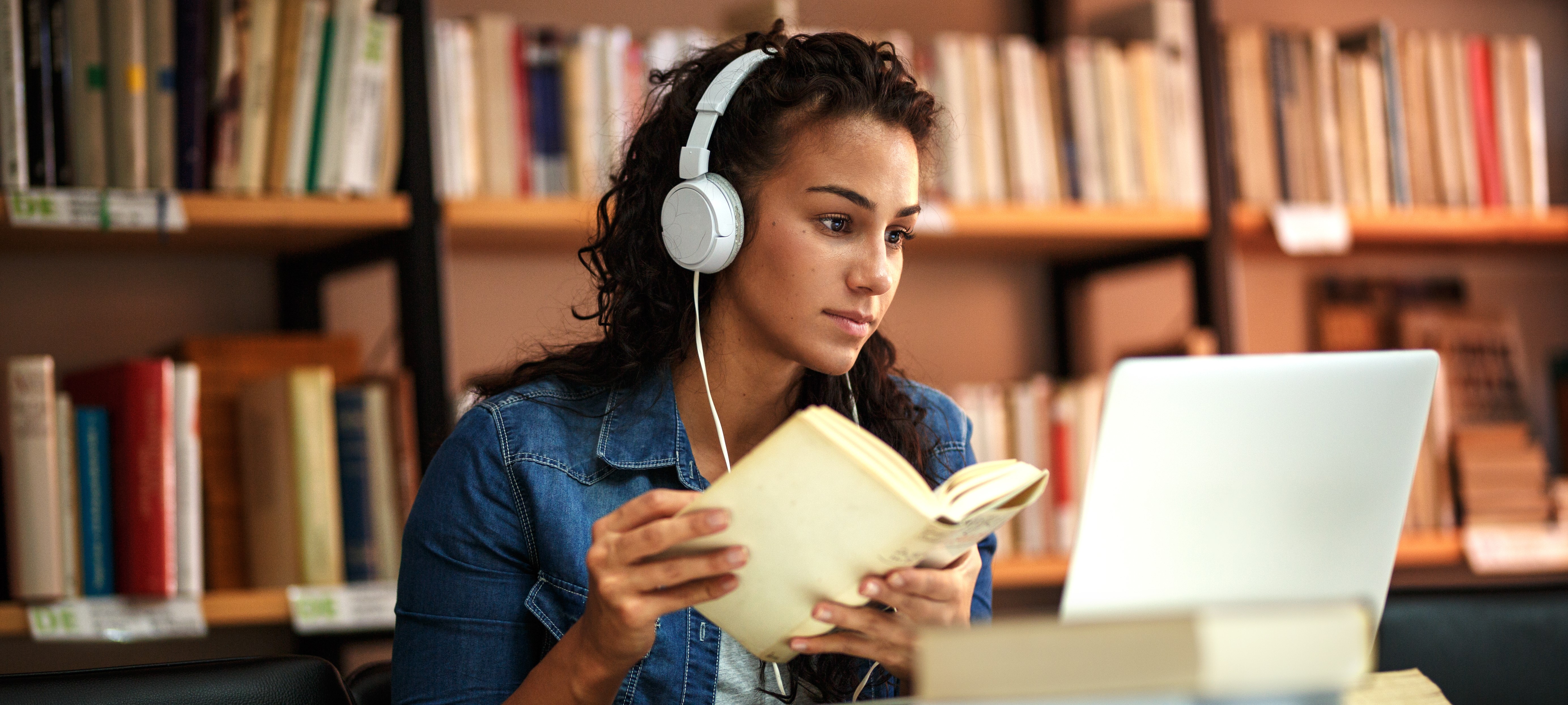 Girl Looking At Laptop And Books