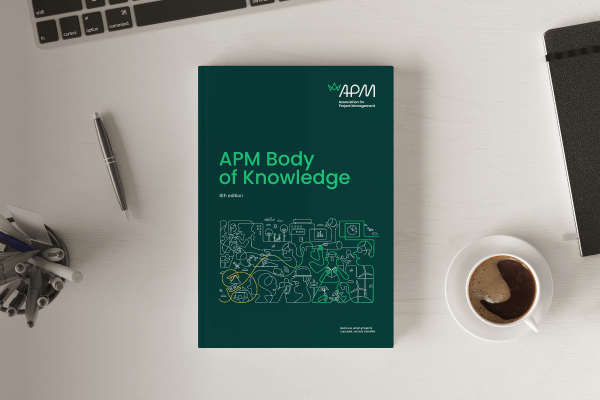 A book titled APM Body of Knowledge placed on an office desk